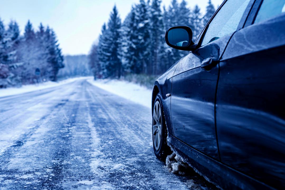 AWD SUV driving on a snowy forest road in upstate New York, showing winter conditions in the Catskills and Adirondacks