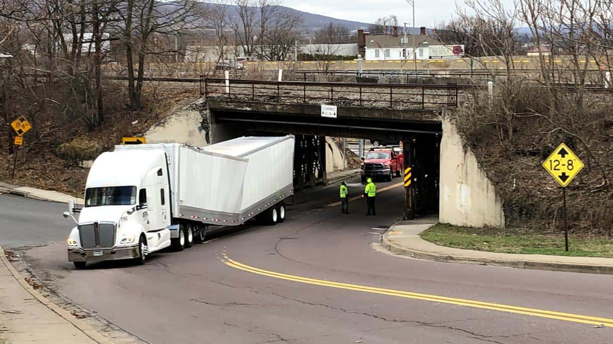 Cargo van stuck under a low clearance bridge on a New York parkway