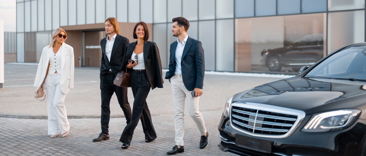  A group of young people walk next to a car