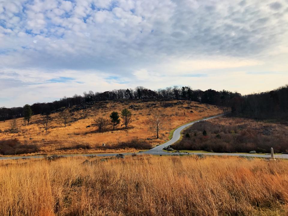 Scenic winding road through the rolling hills and autumn landscape of Hudson Valley, New York.