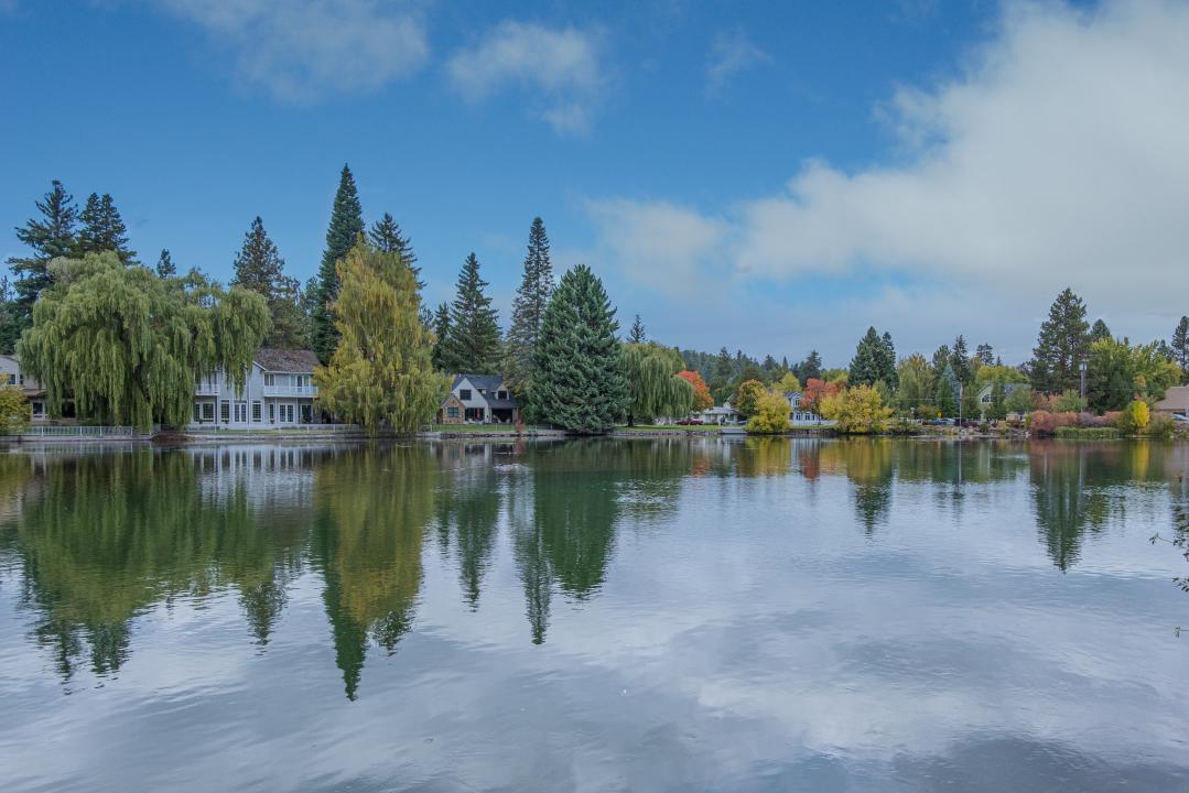 Peaceful view of Lake Placid in the Adirondacks with tree reflections, a perfect crisp mountain escape.